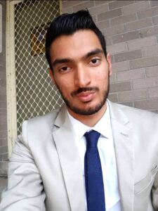 Profile photo of Ismail, wearing a light grey suit, white shirt and a navy tie.